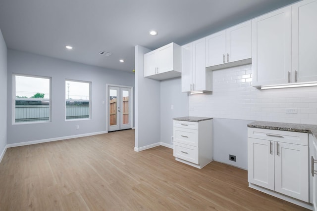18834 Elegance Ave, Spring, TX 77379 - kitchen featuring healthy amount of natural light, backsplash, stone countertops, light wood-style floors, and recessed lighting