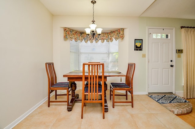 dining area featuring a chandelier, plenty of natural light, and baseboards