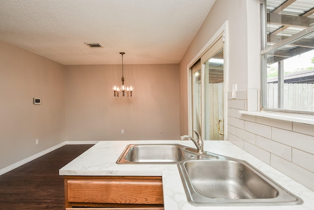 5809 Village Forest Ct, Houston, TX 77092 - kitchen featuring a sink, dark wood finished floors, a chandelier, decorative light fixtures, and baseboards