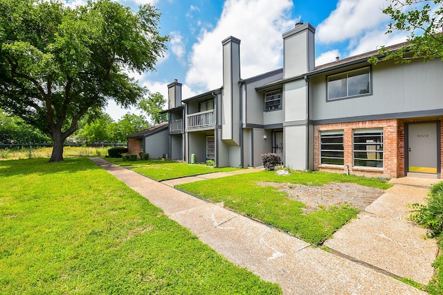 5809 Village Forest Ct, Houston, TX 77092 - back of house with a chimney, a yard, and brick siding