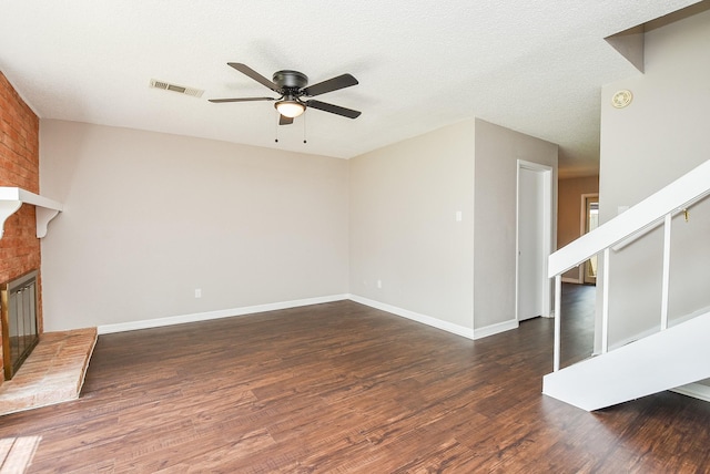 5809 Village Forest Ct, Houston, TX 77092 - unfurnished living room featuring ceiling fan, stairs, wood finished floors, a brick fireplace, and baseboards