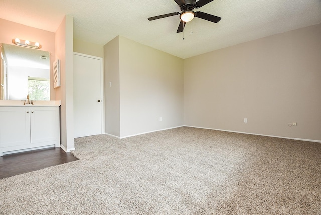 5809 Village Forest Ct, Houston, TX 77092 - unfurnished room with dark carpet, a ceiling fan, a sink, a textured ceiling, and baseboards