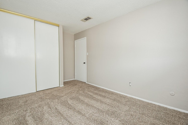 5809 Village Forest Ct, Houston, TX 77092 - unfurnished bedroom with light carpet, a closet, and a textured ceiling
