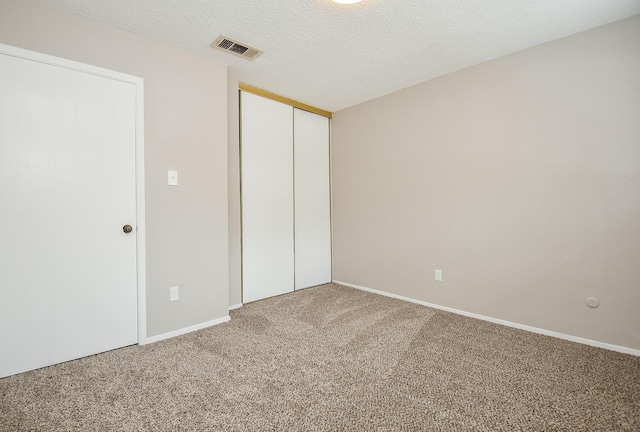 5809 Village Forest Ct, Houston, TX 77092 - unfurnished bedroom with carpet floors, a closet, baseboards, and a textured ceiling