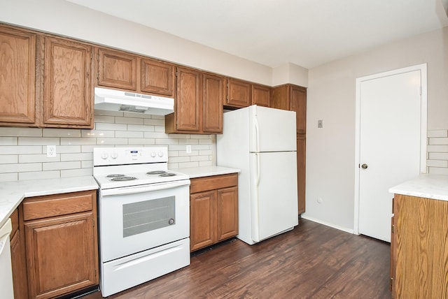 5809 Village Forest Ct, Houston, TX 77092 - kitchen with under cabinet range hood, white appliances, brown cabinets, and light countertops