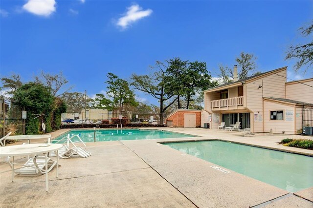 5809 Village Forest Ct, Houston, TX 77092 - community pool with a patio, central air condition unit, a storage unit, and fence