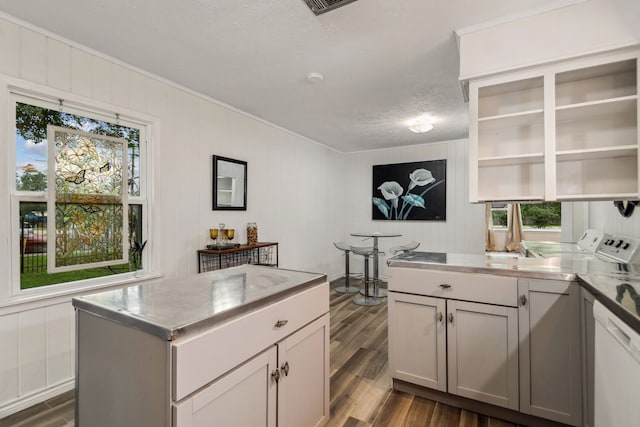 507 Silverdale Dr, Conroe, TX 77301 - kitchen featuring ornamental molding, dark wood finished floors, dishwasher, a textured ceiling, and open shelves