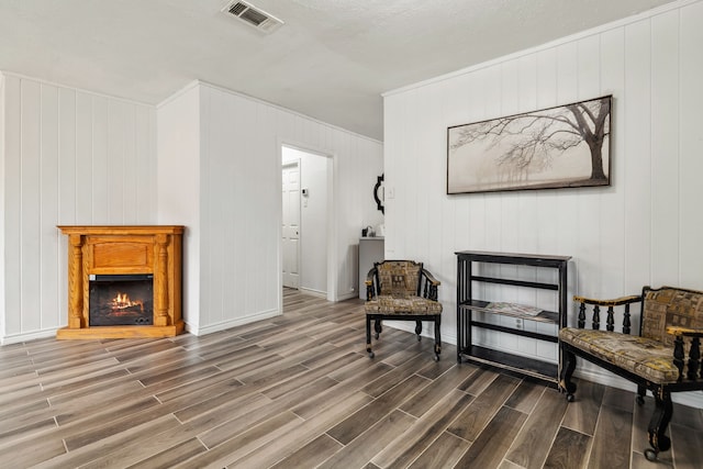 507 Silverdale Dr, Conroe, TX 77301 - living area with wood finished floors, a glass covered fireplace, and baseboards