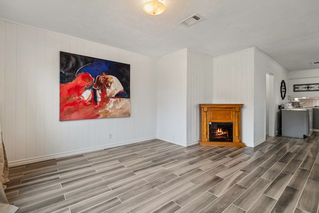 507 Silverdale Dr, Conroe, TX 77301 - unfurnished living room featuring wood finished floors, a lit fireplace, baseboards, and ornamental molding