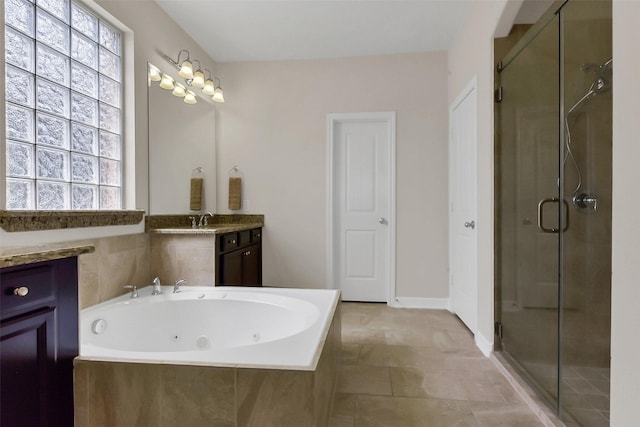 full bathroom with healthy amount of natural light, a stall shower, and a jetted tub