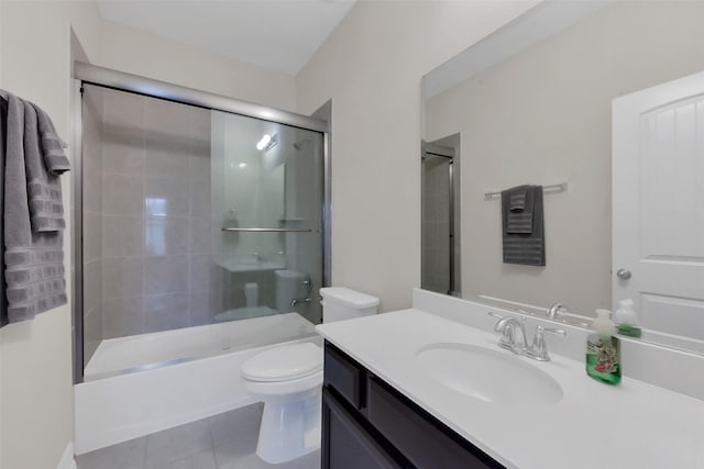 bathroom with tile patterned floors, toilet, vanity, and shower / bathtub combination