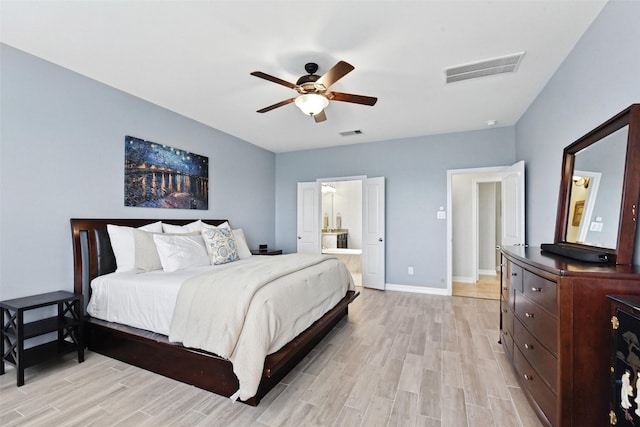 bedroom with light wood-style flooring, baseboards, ensuite bathroom, and a ceiling fan