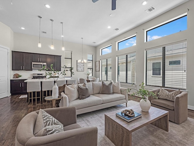 110 N Hutcheson St, Houston, TX 77003 - living area featuring a chandelier, dark wood-type flooring, a ceiling fan, recessed lighting, and a high ceiling