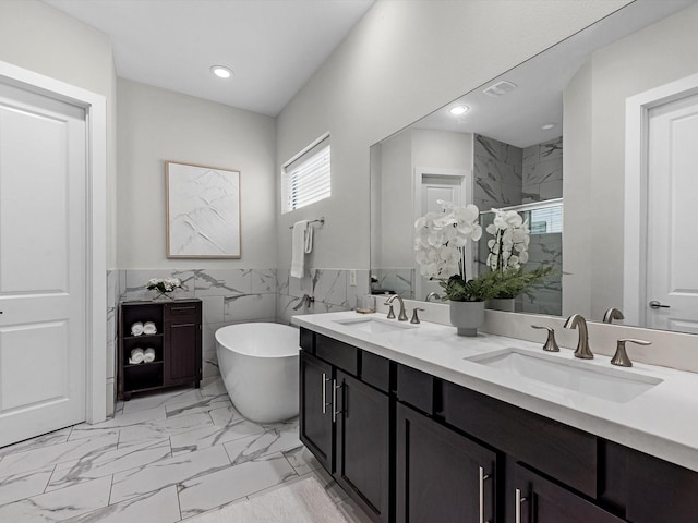 110 N Hutcheson St, Houston, TX 77003 - full bathroom with a stall shower, a soaking tub, marble look tile flooring, wainscoting, and tile walls