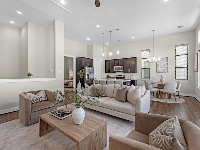 110 N Hutcheson St, Houston, TX 77003 - living area featuring light wood finished floors, a chandelier, recessed lighting, baseboards, and attic access