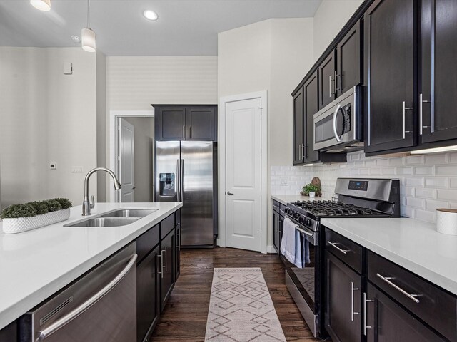 110 N Hutcheson St, Houston, TX 77003 - kitchen with appliances with stainless steel finishes, a sink, light countertops, dark wood-style flooring, and recessed lighting