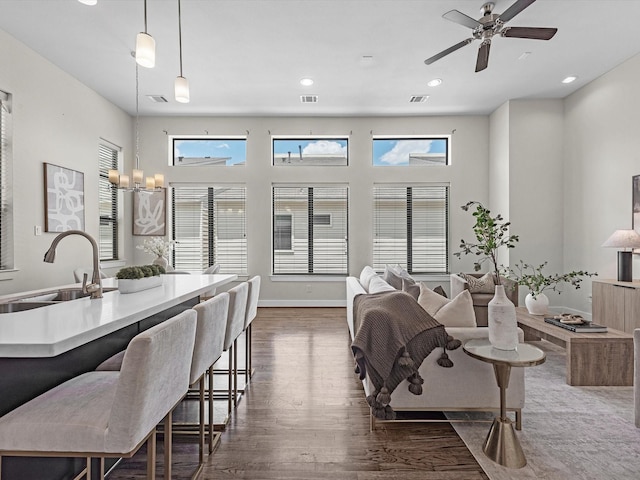 110 N Hutcheson St, Houston, TX 77003 - living area featuring dark wood-type flooring, a ceiling fan, recessed lighting, and baseboards