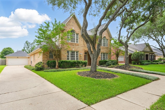 4027 Austin Meadow Dr, Sugar Land, TX 77479 - traditional-style house with brick siding, a front yard, an outbuilding, and a detached garage