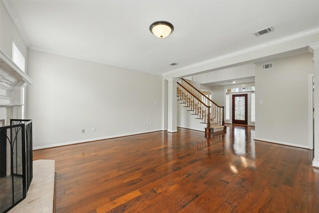 4027 Austin Meadow Dr, Sugar Land, TX 77479 - unfurnished living room with stairway, crown molding, wood-type flooring, baseboards, and decorative columns