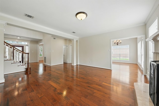 4027 Austin Meadow Dr, Sugar Land, TX 77479 - unfurnished living room with hardwood / wood-style floors, a chandelier, stairway, crown molding, and baseboards