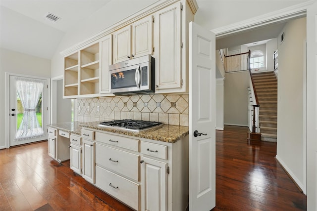 4027 Austin Meadow Dr, Sugar Land, TX 77479 - kitchen with appliances with stainless steel finishes, dark wood finished floors, decorative backsplash, open shelves, and light stone countertops