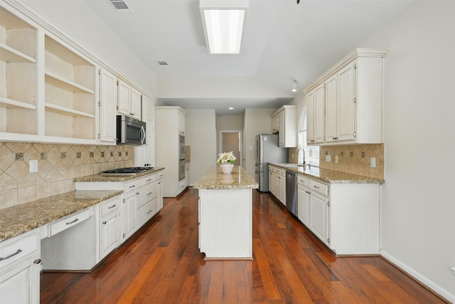 4027 Austin Meadow Dr, Sugar Land, TX 77479 - kitchen with stainless steel appliances, a kitchen island, dark wood finished floors, and a sink