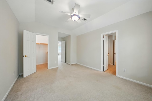 4027 Austin Meadow Dr, Sugar Land, TX 77479 - unfurnished bedroom featuring light colored carpet, a spacious closet, baseboards, vaulted ceiling, and ensuite bath
