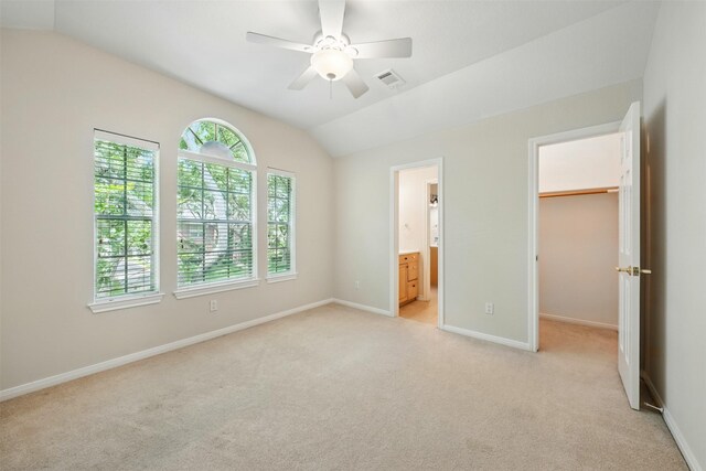 4027 Austin Meadow Dr, Sugar Land, TX 77479 - unfurnished bedroom with vaulted ceiling, a spacious closet, light colored carpet, baseboards, and ensuite bath
