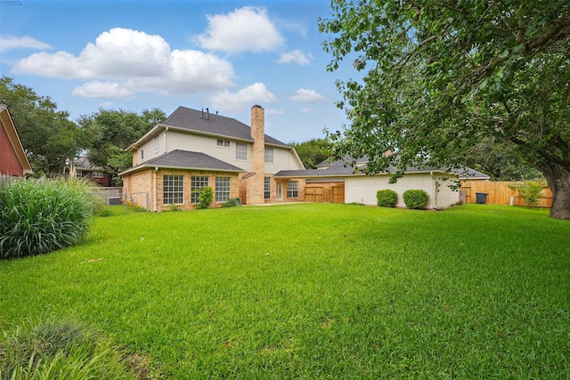 4027 Austin Meadow Dr, Sugar Land, TX 77479 - back of house with a chimney and brick siding