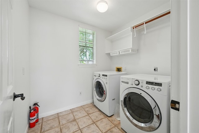 4027 Austin Meadow Dr, Sugar Land, TX 77479 - laundry area with washer and dryer, baseboards, and light tile patterned floors