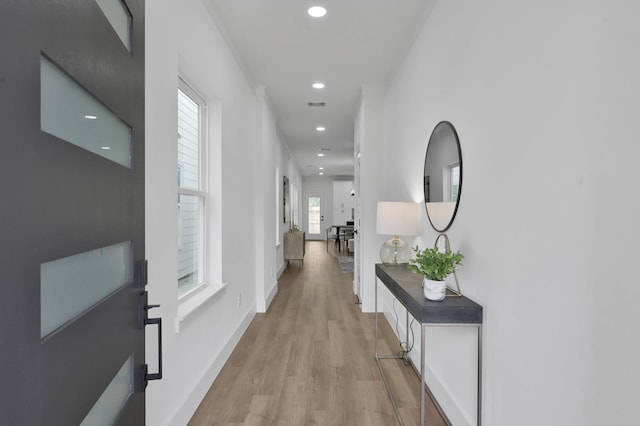 hall with light wood-style floors, recessed lighting, and baseboards