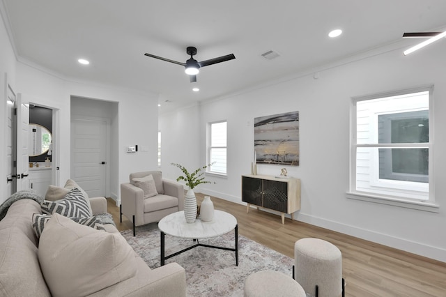 living area featuring crown molding, wood finished floors, ceiling fan, baseboards, and recessed lighting