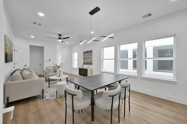 dining room with light wood finished floors, ornamental molding, baseboards, recessed lighting, and ceiling fan