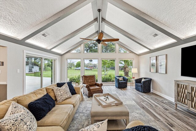 20316 County Road 510b, Brazoria, TX 77422 - living area with a textured ceiling, wood finished floors, baseboards, and a ceiling fan