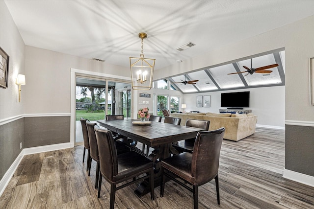 20316 County Road 510b, Brazoria, TX 77422 - dining space with wood finished floors, baseboards, a chandelier, and a ceiling fan