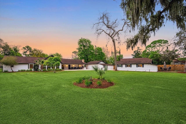 20316 County Road 510b, Brazoria, TX 77422 - yard at dusk featuring a lawn, concrete driveway, and a patio