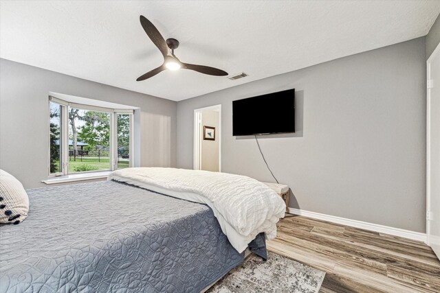 20316 County Road 510b, Brazoria, TX 77422 - bedroom featuring wood finished floors, baseboards, and ceiling fan