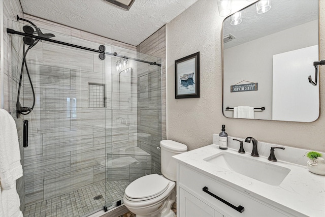 20316 County Road 510b, Brazoria, TX 77422 - bathroom with a textured ceiling, toilet, a shower stall, vanity, and a textured wall
