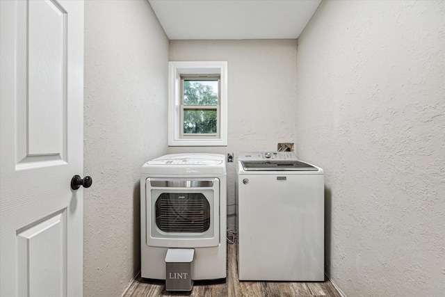20316 County Road 510b, Brazoria, TX 77422 - laundry area featuring washer and dryer, wood finished floors, and a textured wall