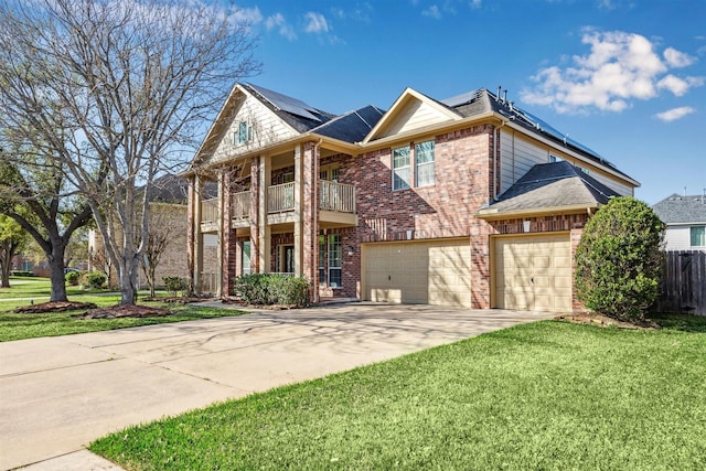 11405 Starlight Bay St, Pearland, TX 77584 - view of front of home with a balcony, driveway, brick siding, roof mounted solar panels, and a garage
