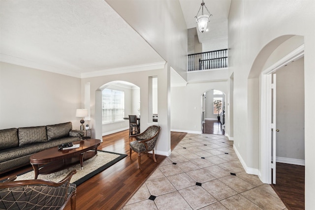 11405 Starlight Bay St, Pearland, TX 77584 - tiled foyer entrance featuring arched walkways, ornamental molding, and baseboards