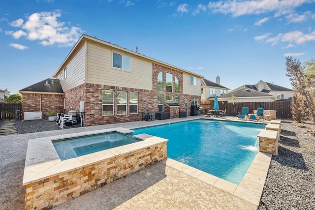 11405 Starlight Bay St, Pearland, TX 77584 - view of swimming pool featuring a patio, a fenced backyard, and a pool with connected hot tub