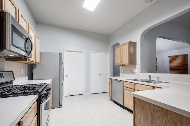 4523 Bridgevillage Dr, Spring, TX 77373 - kitchen with appliances with stainless steel finishes, a sink, light brown cabinets, and arched walkways