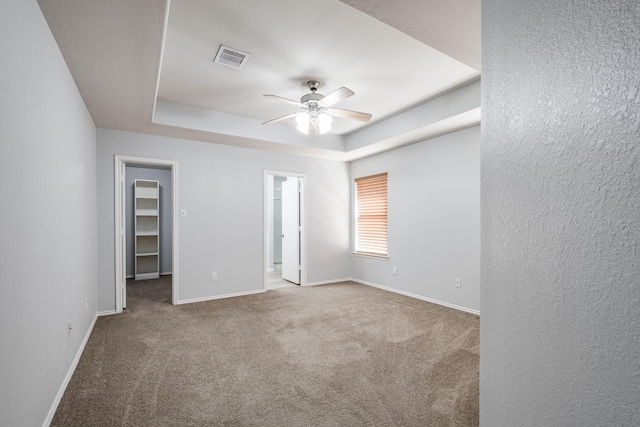 4523 Bridgevillage Dr, Spring, TX 77373 - unfurnished room with a tray ceiling, ceiling fan, carpet, and baseboards