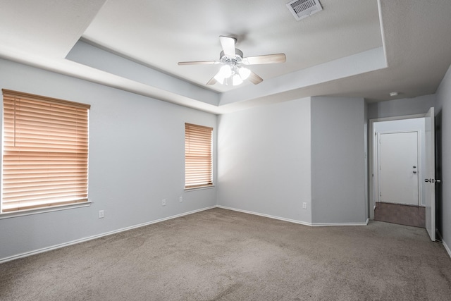 4523 Bridgevillage Dr, Spring, TX 77373 - carpeted spare room featuring a tray ceiling, ceiling fan, and baseboards
