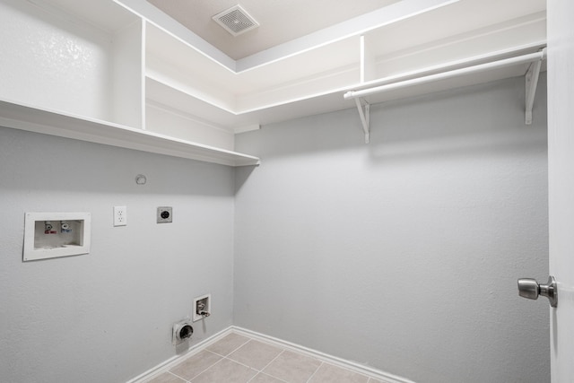 4523 Bridgevillage Dr, Spring, TX 77373 - clothes washing area with electric dryer hookup, washer hookup, hookup for a gas dryer, baseboards, and light tile patterned floors