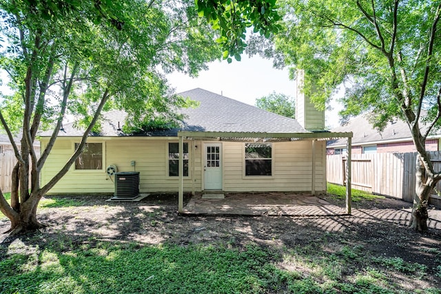 4523 Bridgevillage Dr, Spring, TX 77373 - rear view of property featuring a patio, a chimney, fence, cooling unit, and roof with shingles