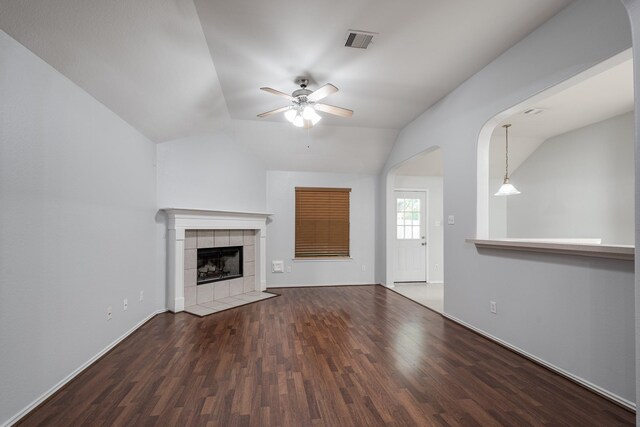 4523 Bridgevillage Dr, Spring, TX 77373 - unfurnished living room with lofted ceiling, ceiling fan, wood finished floors, a tiled fireplace, and baseboards