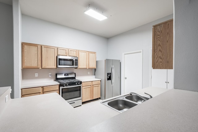 4523 Bridgevillage Dr, Spring, TX 77373 - kitchen featuring appliances with stainless steel finishes, a sink, light brown cabinets, and light countertops