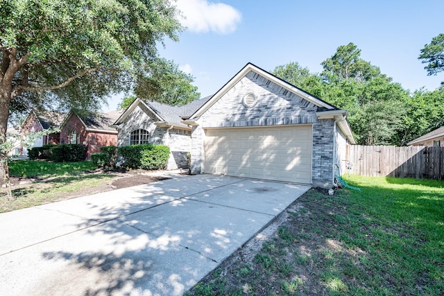 4523 Bridgevillage Dr, Spring, TX 77373 - view of front facade featuring driveway, an attached garage, stone siding, and brick siding